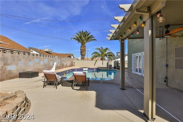 view of pool with french doors and a patio