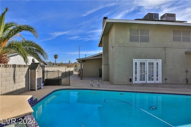 view of pool with french doors