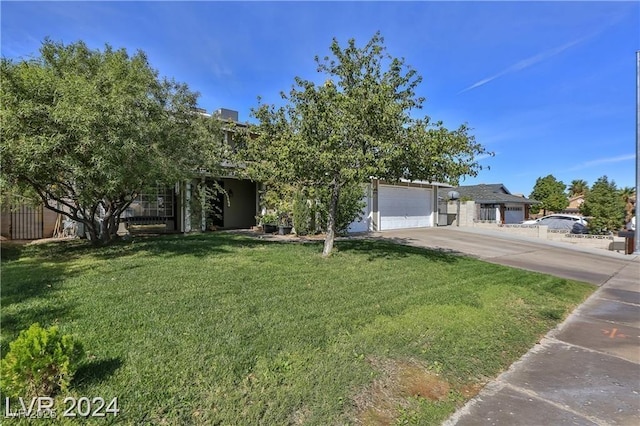 view of front of property featuring a garage and a front yard