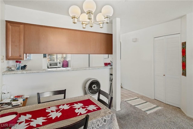 clothes washing area featuring light colored carpet and a notable chandelier