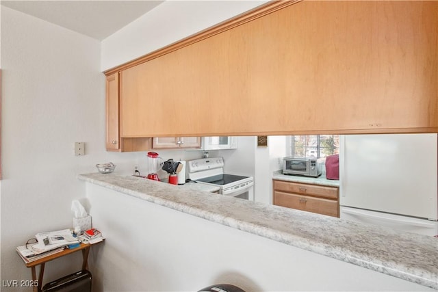 kitchen with white appliances and light brown cabinetry