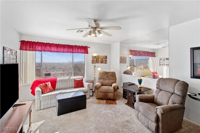 living room featuring carpet and ceiling fan