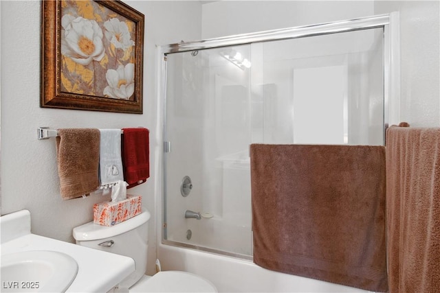 full bathroom with enclosed tub / shower combo, vanity, and toilet