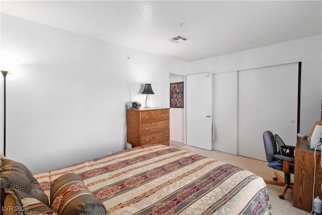 carpeted bedroom with a closet