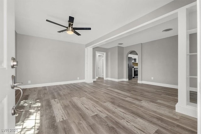 unfurnished living room featuring ceiling fan and hardwood / wood-style floors