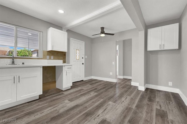 kitchen with white cabinetry, sink, beam ceiling, and dark hardwood / wood-style floors