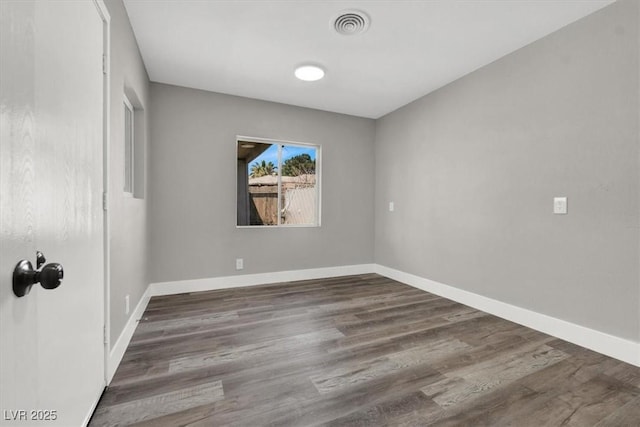 unfurnished room with dark hardwood / wood-style floors