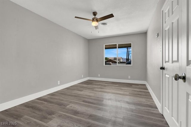 spare room with hardwood / wood-style flooring, ceiling fan, and a textured ceiling