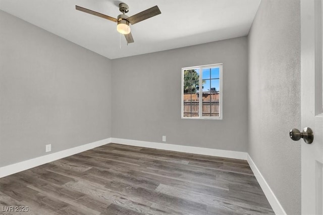 spare room featuring ceiling fan and dark hardwood / wood-style flooring