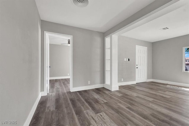 empty room with dark hardwood / wood-style floors