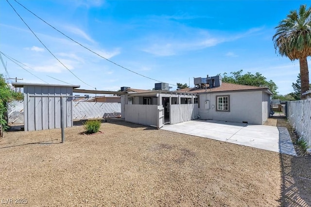 rear view of property with a patio area and central air condition unit