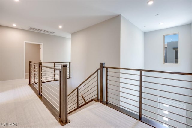 stairway featuring carpet floors