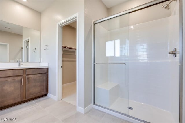 bathroom with vanity and a shower with shower door