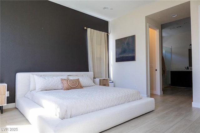 bedroom with light wood-type flooring