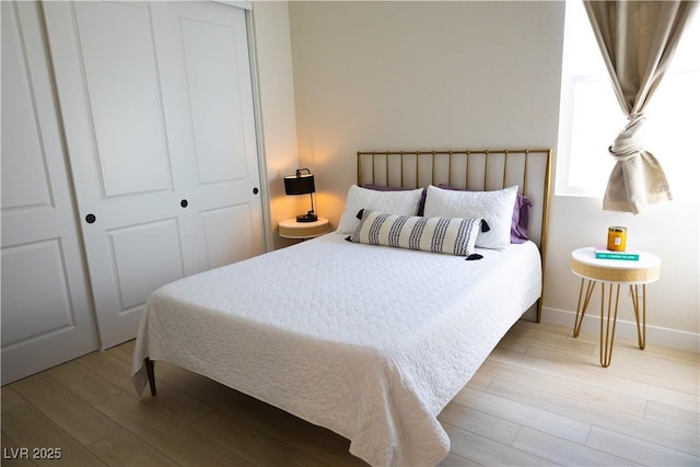 bedroom with a closet and light hardwood / wood-style flooring