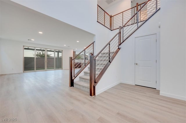 stairs featuring hardwood / wood-style floors