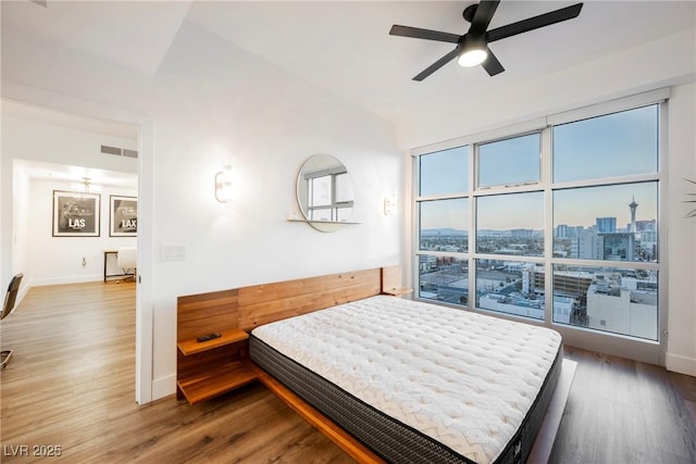 bedroom featuring wood-type flooring and vaulted ceiling