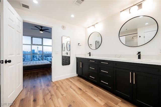 bathroom with vanity, wood-type flooring, and ceiling fan