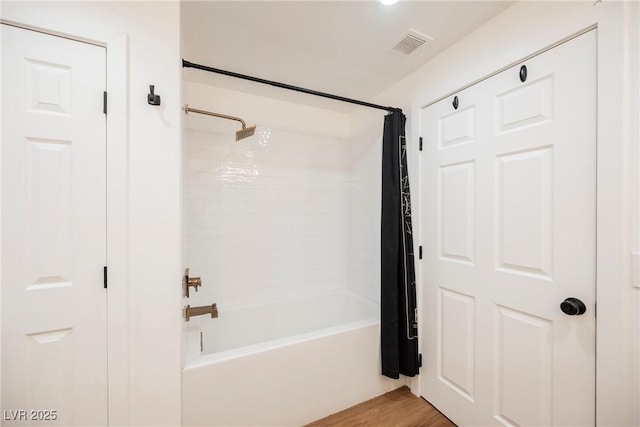 bathroom featuring shower / tub combo and hardwood / wood-style floors