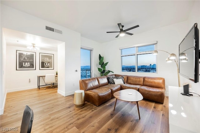 living room with hardwood / wood-style floors and ceiling fan