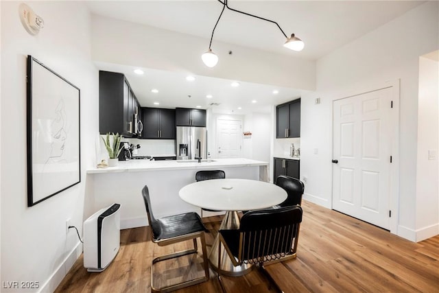 dining space featuring light wood-type flooring