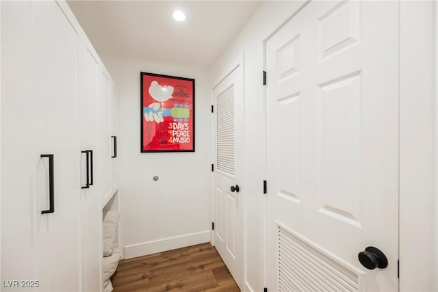 corridor with hardwood / wood-style floors