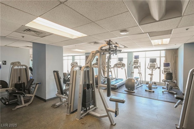 exercise room with a paneled ceiling