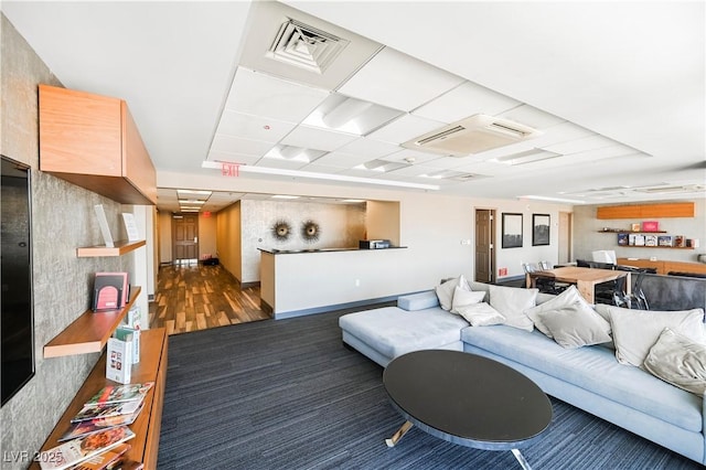 living room with a paneled ceiling