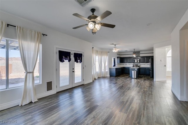 unfurnished living room with french doors and dark wood-type flooring