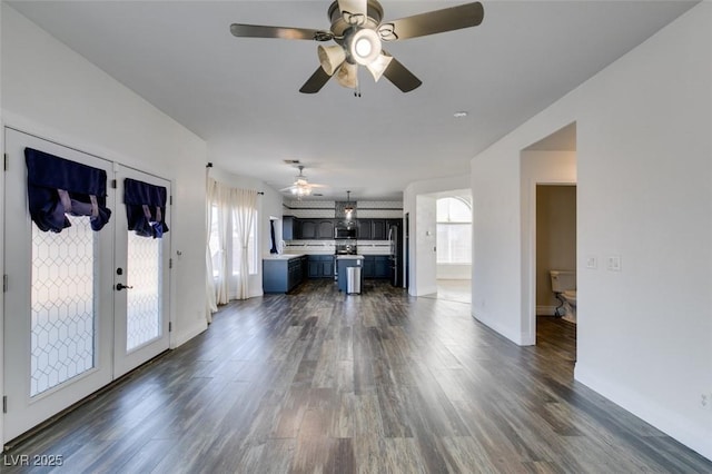 unfurnished living room with dark hardwood / wood-style floors and ceiling fan