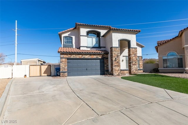 mediterranean / spanish home with a garage and a front lawn