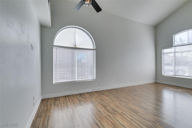 spare room with lofted ceiling, ceiling fan, and light wood-type flooring