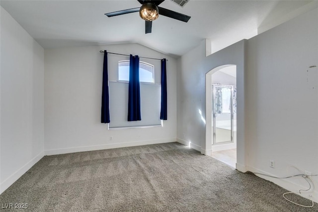 carpeted empty room featuring vaulted ceiling and ceiling fan