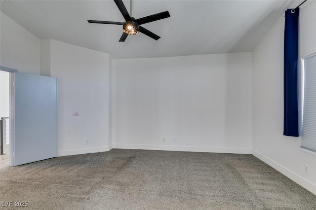 carpeted spare room featuring ceiling fan