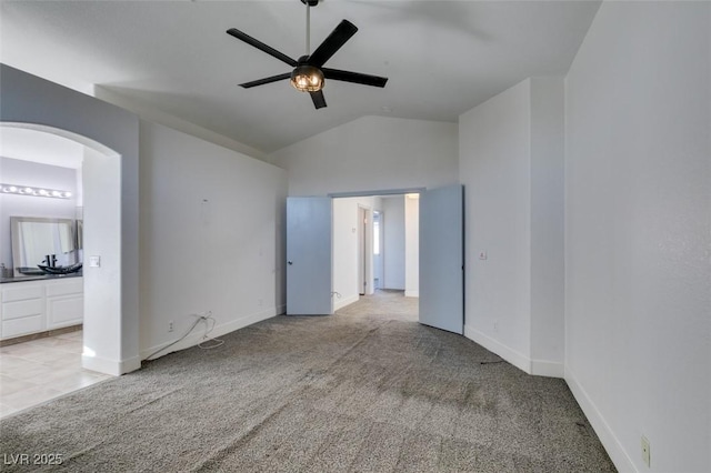 carpeted empty room featuring lofted ceiling and ceiling fan