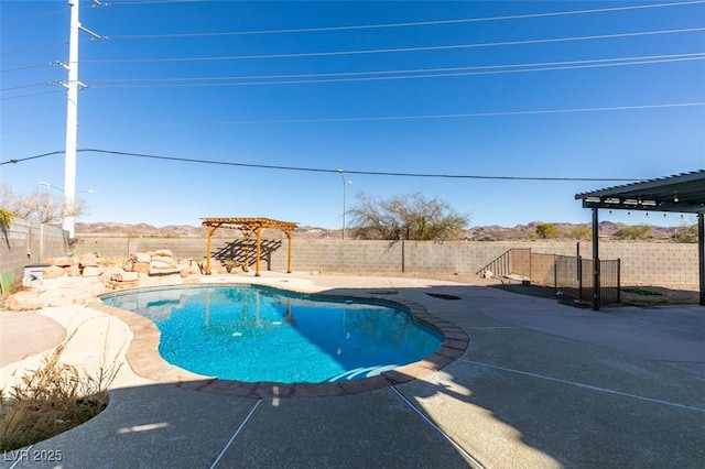 view of pool with a mountain view, a pergola, and a patio