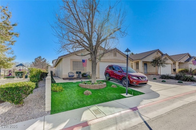 single story home featuring a garage and a front lawn