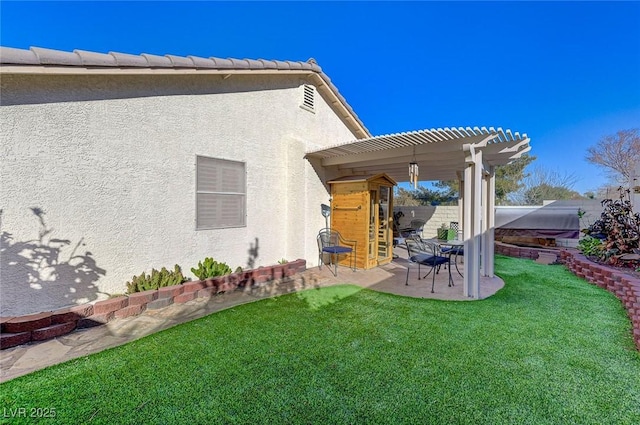 back of property with a yard, a pergola, and a patio