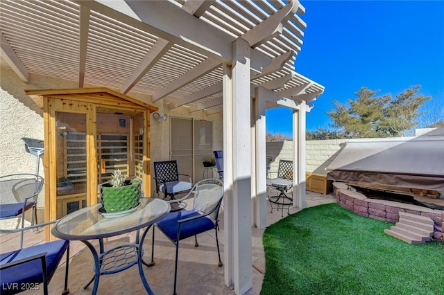 view of patio featuring a covered hot tub and a pergola