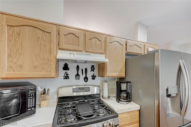 kitchen featuring appliances with stainless steel finishes and light brown cabinetry