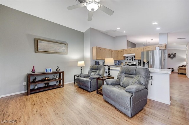 living room featuring vaulted ceiling, ceiling fan, and light hardwood / wood-style floors