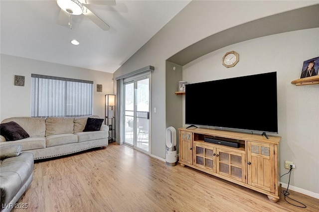 living room with wood-type flooring, ceiling fan, and vaulted ceiling