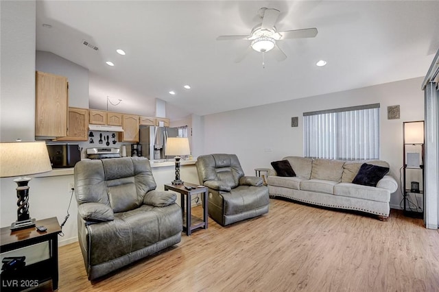 living room with ceiling fan, lofted ceiling, and light wood-type flooring