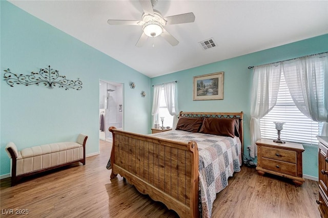 bedroom with ceiling fan, vaulted ceiling, and light hardwood / wood-style flooring