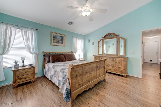 bedroom with lofted ceiling, multiple windows, ceiling fan, and light hardwood / wood-style flooring