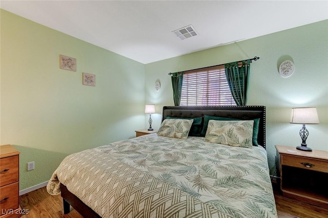 bedroom with hardwood / wood-style floors