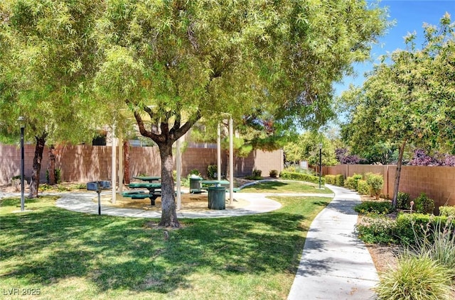 surrounding community with a yard and a patio