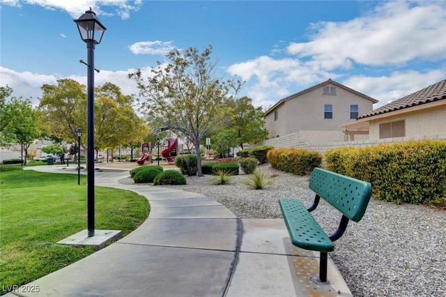 view of community with a lawn and a playground