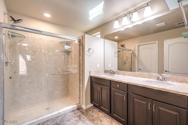 5490 Tulip Hill Ave, Las Vegas, NV 89141 - bathroom featuring a shower stall, double vanity, and recessed lighting