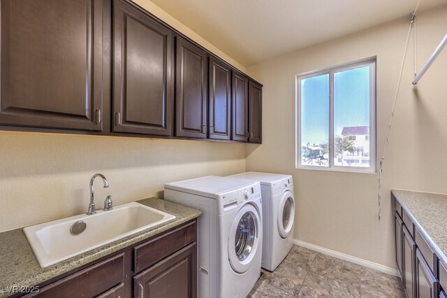 5490 Tulip Hill Ave, Las Vegas, NV 89141 - laundry room with cabinet space, washer and clothes dryer, and baseboards